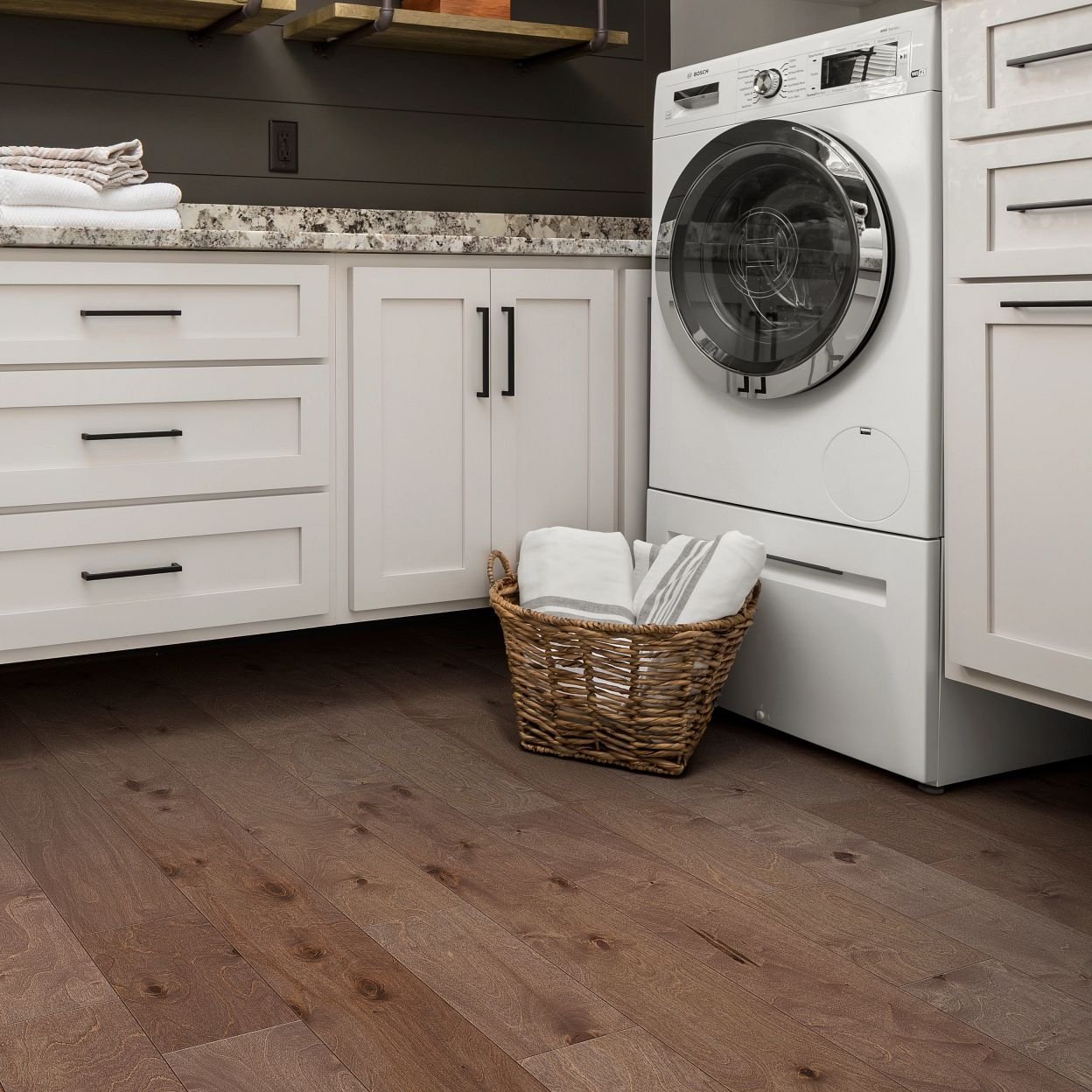 Kitchen with a basket of laundry on hardwood flooring from Value Flooring Kitchens & Baths in Cleveland, TN